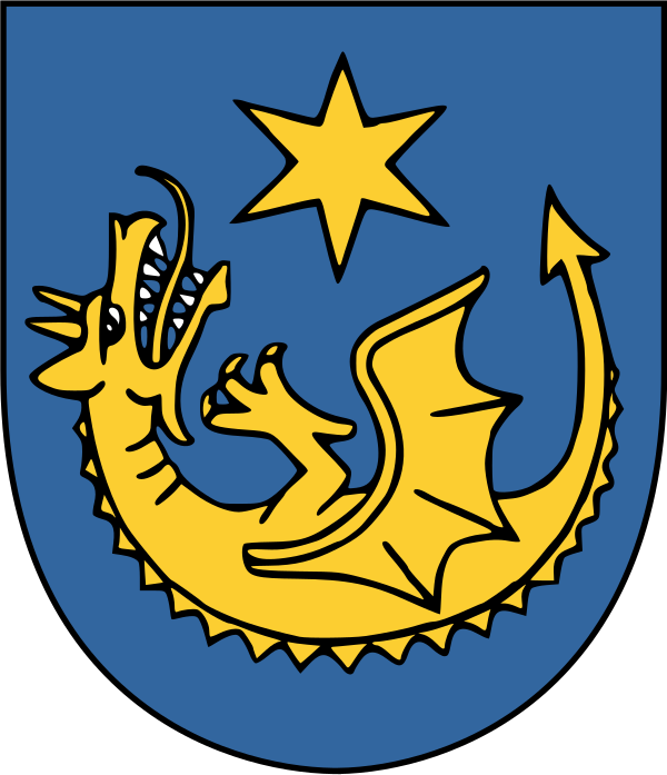 Na obrazku widoczny jest herb Powiatu Strzyżowskiego w kolorze głównie niebieskim. Po lewej stronie znajduje się żółty kształt przypominający stylizowaną rybę lub stworzenie morskie, umieszczony na niebieskim tle
